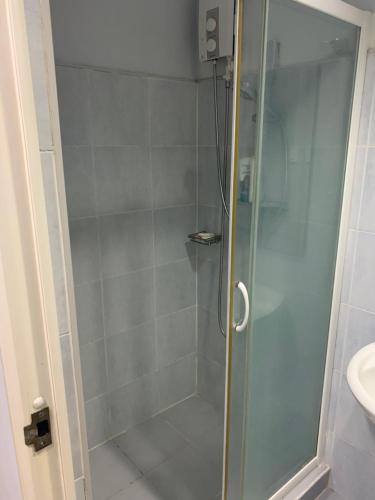 a shower with a glass door in a bathroom at 1 BR CONDO SEA RESIDENCES in Manila