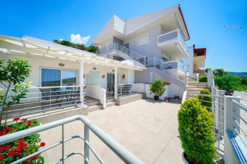 a view of a house with a balcony at Tarsa's House by the Sea in Skala Marion