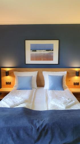 a large bed with two pillows in a bedroom at Willa Abrazja - wypoczynek dla dorosłych in Jastrzębia Góra