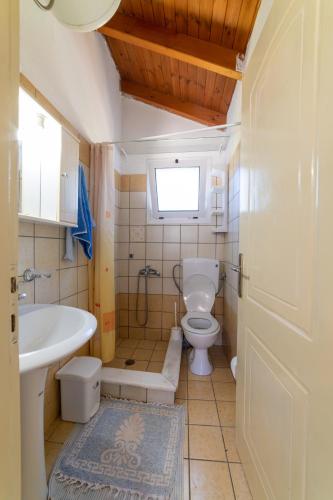 a bathroom with a toilet and a sink at Lambrini Studios in Parga