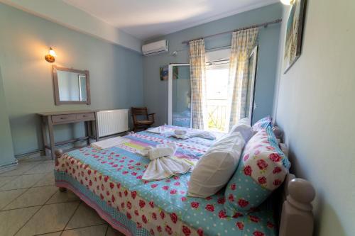 a bedroom with a bed with stuffed animals on it at Lambrini Studios in Parga
