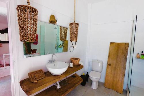 a bathroom with a sink and a toilet at The Summer Pink House in Lachania