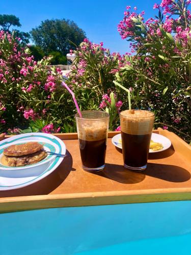 two cups of coffee and a plate of food on a tray at The Summer Pink House in Lachania