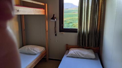 A bed or beds in a room at Bjarnastaðir Guesthouse