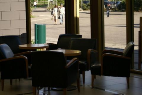 a group of chairs and tables in a building at Imatra Spa Sport Camp in Imatra