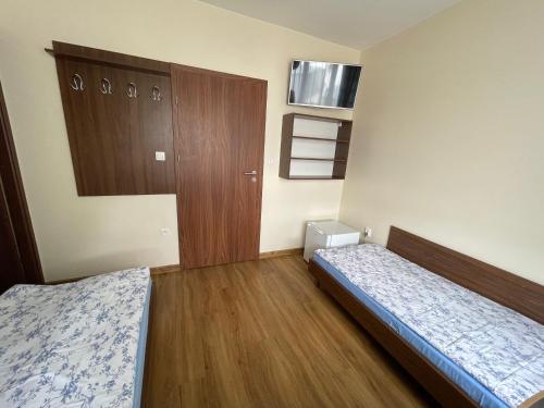 a small room with two beds and a cabinet at ANNA NOCLEGI in Raszyn