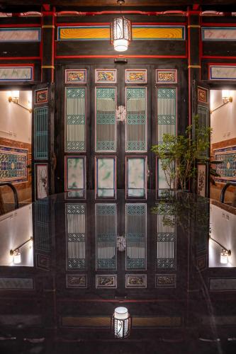 una puerta en un restaurante con una planta delante en Kinmenhouse of Old Tiles No 4, en Jincheng