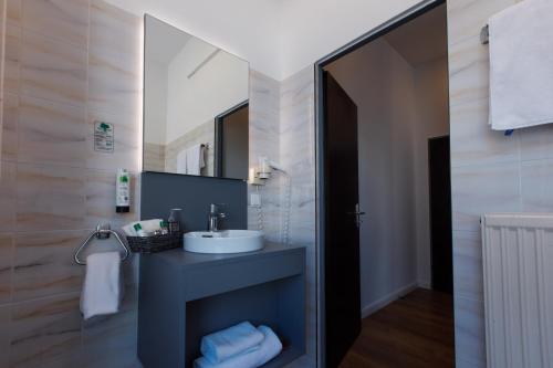 a bathroom with a sink and a mirror at Florum Hotel in Vienna