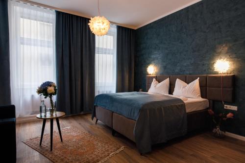 a hotel room with a bed and a chandelier at Florum Hotel in Vienna