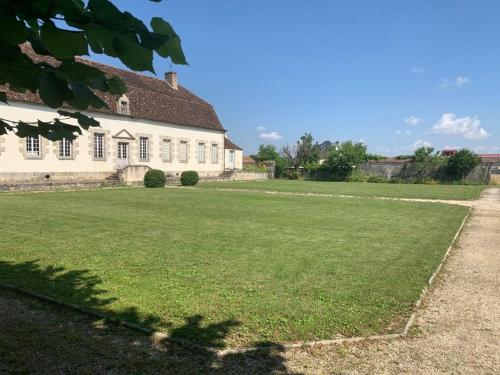 a large grass field in front of a building at Demeure Saint Martin in Sourdun
