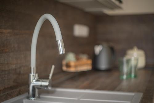 a kitchen sink with a faucet on a counter at Stará Celnice Kvilda in Kvilda