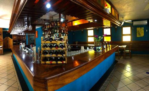 a bar with a bunch of bottles of wine at Hotel Pez Vela in Manzanillo