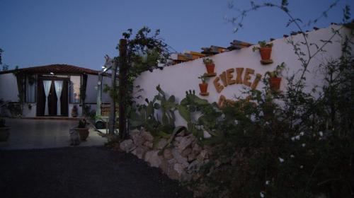 a white house with plants on the side of it at B&B Eyexei Domus in Agrigento