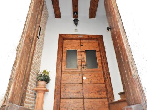 a wooden door in a room with a vase at Zupan 1 - apartman in Krk