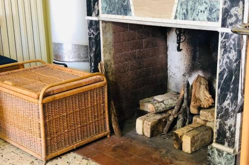 a room with a fireplace with logs in it at Casa Palazzo Civitanova in Civitanova del Sannio