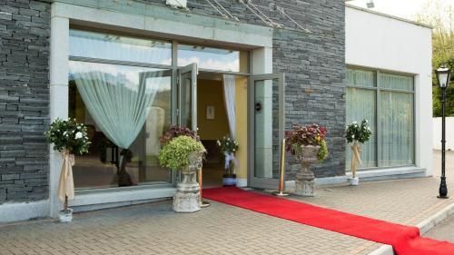 a building with a red carpet and a window at Kettles Country House Hotel in Swords