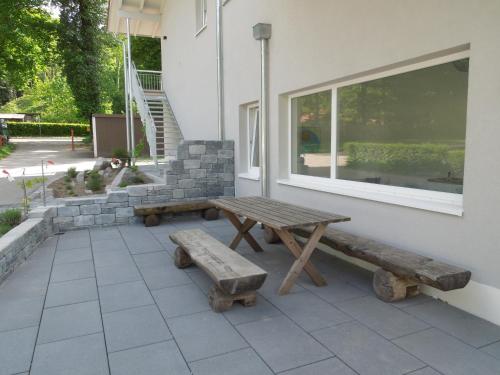a picnic table and bench next to a window at Busses Guesthouse in Freiburg im Breisgau