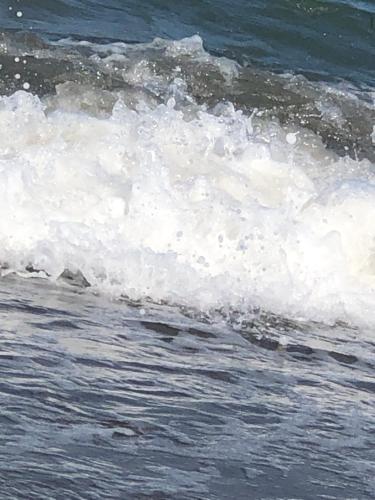 a wave in the ocean with foam on the water at Casa Olivia villa in Arboleas