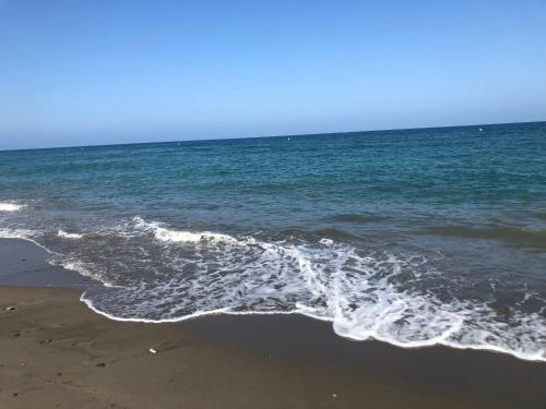 a beach with the ocean and the shoreline at Casa Olivia villa in Arboleas