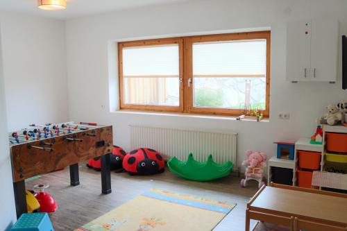 a room with a table and some toys in it at Ferienpension Steiner in Weerberg