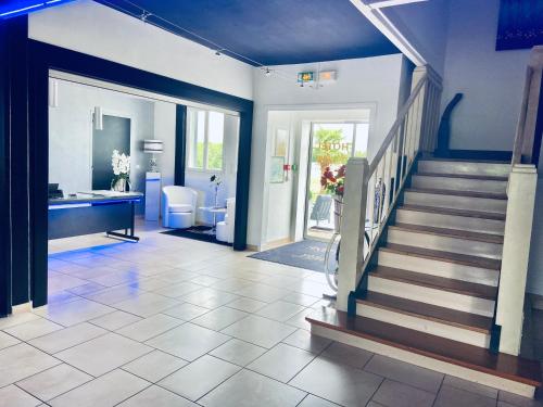 a hallway with a staircase in a house at Hotel Air-lane in Saint-Léger-sous-Brienne