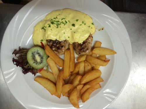 a plate of food with a hamburger and french fries at Gasthof zur Post in Siegen
