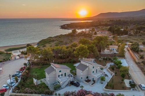 an aerial view of a house with the sunset in the background at Seashell Luxury Residence - Apartment 1 in Lixouri