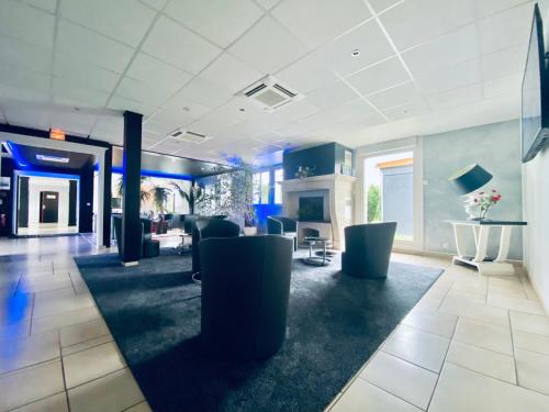 a lobby with couches and chairs in a building at Hotel Air-lane in Saint-Léger-sous-Brienne