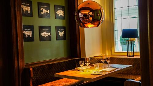 a table in a restaurant with a mirror on the wall at Altes Zollhaus in Rinteln