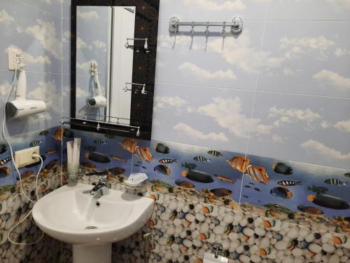 a bathroom with a sink and a mirror at Hotel Goldenera in Kutaisi