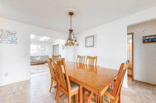 a dining room with a wooden table and chairs at Tidal Links - 4 Bed 3 Bath Vacation home in Bandon Dunes in Bandon