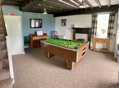 a room with a pool table in a room at Garth- Stunning Scenic semi-rural Cottage with Games room in Conwy