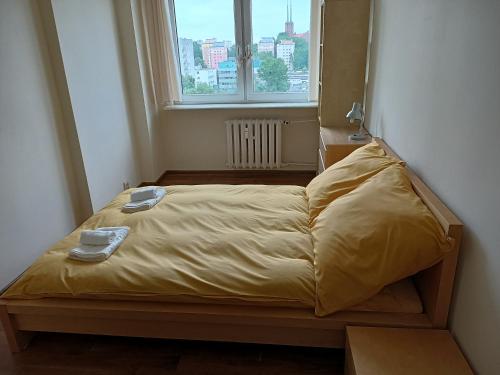 a bed in a small room with a window at Apartament Mimi in Gdynia