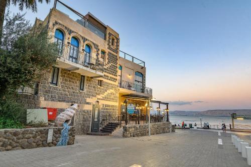 a building with a teddy bear standing in front of it at Shirat Hayam Boutique Hotel in Tiberias