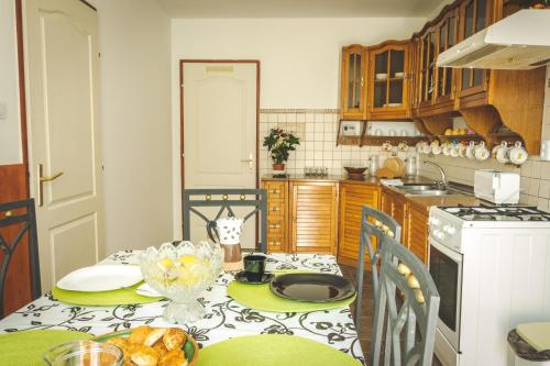 a kitchen with a table with a plate of food on it at Linett Apartman in Hajdúszoboszló