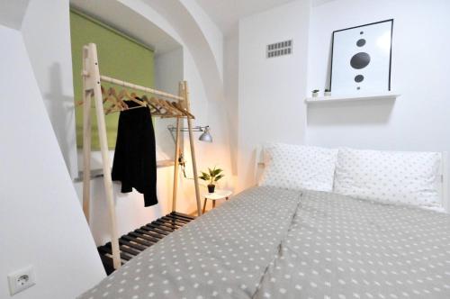 a bedroom with a bed in a room with a ladder at The Maze Apartment in Ljubljana