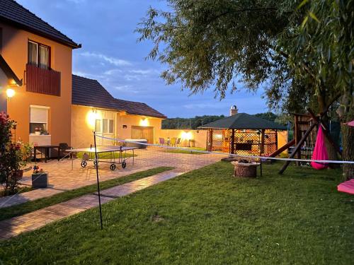 a backyard with a playground at Linett Apartman in Hajdúszoboszló
