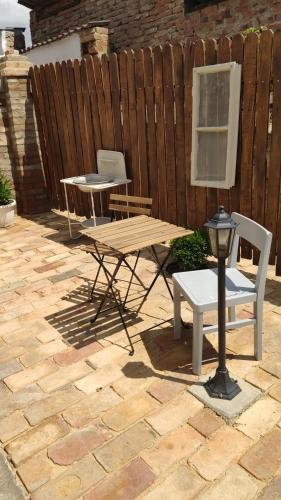 a picnic table and a table and chairs on a patio at Bíborlak in Villány