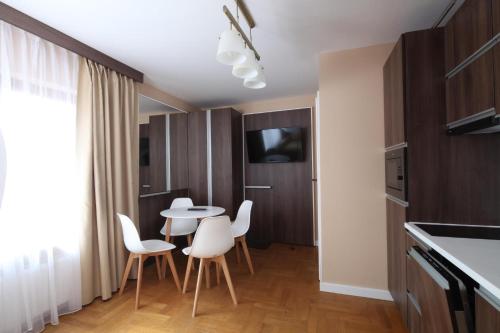 a kitchen with a table and chairs in a room at Willa Nova in Wisła