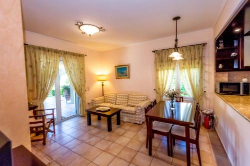 a living room with a couch and a table at Wave and Sea Holiday Home in Barbati