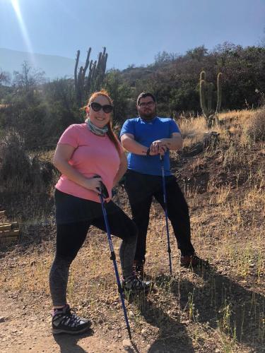 a man and a woman standing on a trail at Origen del Maipo Lodge in San José de Maipo