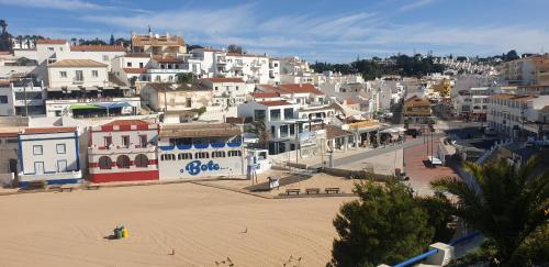 a view of a town with a beach and buildings at FM Central Vila Apartment in Carvoeiro