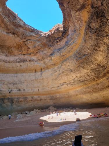 a view of a beach from inside a cave at FM Central Vila Apartment in Carvoeiro