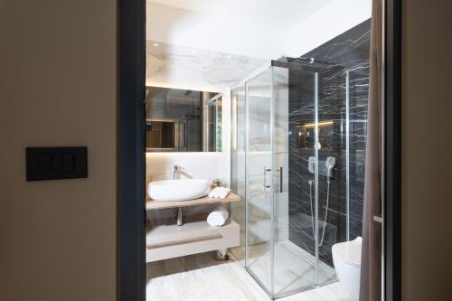 a bathroom with a glass shower and a sink at Premium Apartments with balcony in Rijeka