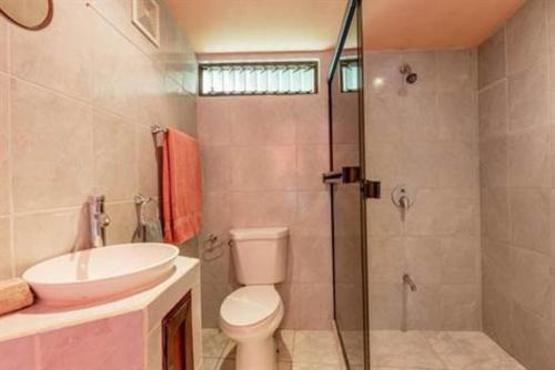 a bathroom with a toilet and a sink and a shower at Casa Melosa in Potrero