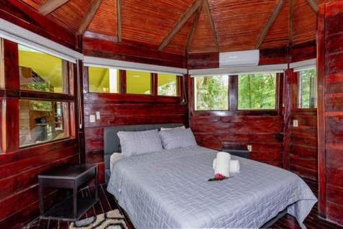 a bedroom with a bed in a room with windows at Casa Melosa in Potrero