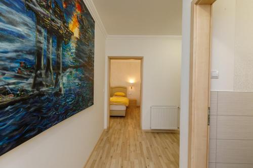 a painting hanging on a wall in a room at Andi Apartman in Hévíz