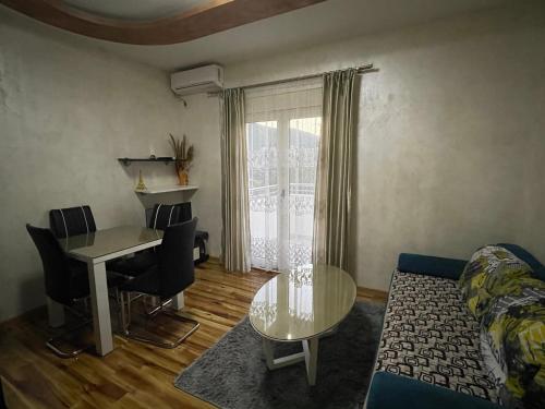 a living room with a couch and a table at Apartment Zevs 1 in Budva