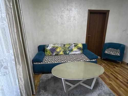 a living room with a blue couch and a table at Apartment Zevs 1 in Budva