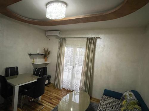 a living room with a table and a window at Apartment Zevs 1 in Budva